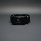 Black Burberry belt on a glass display case with blurred background